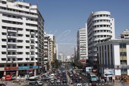 Image du Maroc Professionnelle de  Dans les années 50 apparaît le nouveau quartier d’affaire de Sidi Belyout, construit dans un style jusque-là inconnu. Son exécution était prévue par un plan d’ensemble d’Ecochard, approuvé en 1952.L’avenue des F.A.R., à gauche, représente l’une des plus grandes réussites de ce projet. Bordée d’une suite de hauts immeubles d’un aspect très agréable et bien entretenus, elle bénéficie également d’un élargissement spatial considérable, dû à l’originalité architecturale de ses constructions en biais (la rangée du milieu), Mardi 7 Juillet 2009. (Photo / Abdeljalil Bounhar) 